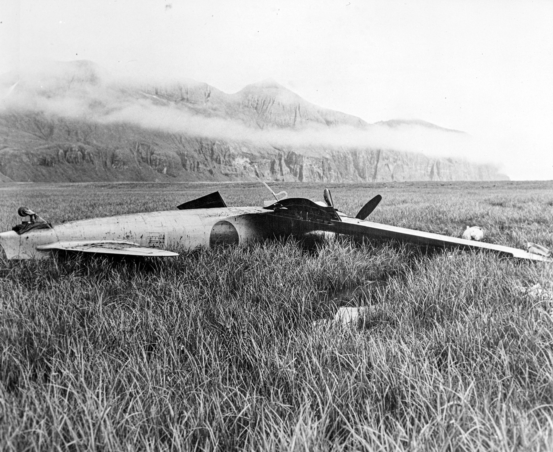 The Akutan Zero, upside-down in the bog as it was found by the salvage party.