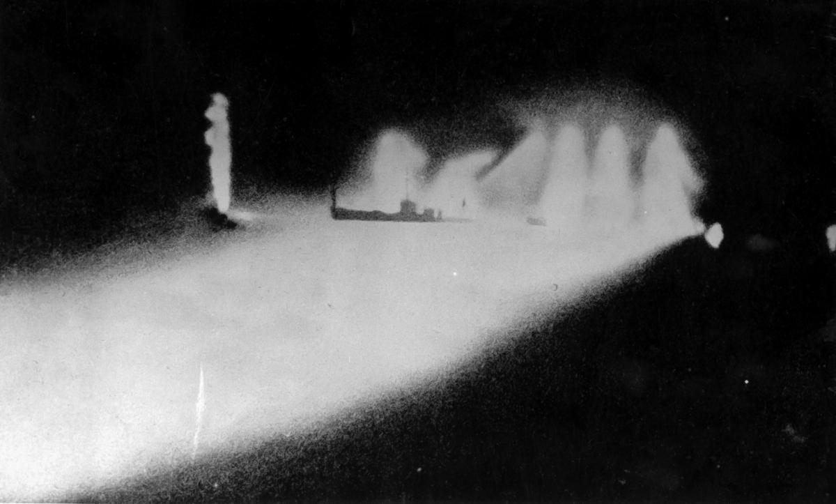 USS Quincy (CA-39) photographed from a Japanese cruiser during the Battle of Savo Island, off Guadalcanal, 9 August 1942.