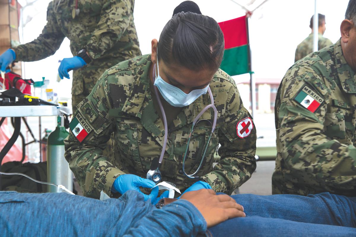 Mexican Navy Lieutenant Ruth B. Bolanos, a combat nurse, treats a simulated casualty during a humanitarian and disaster relief demonstration as part of the Rim of the Pacific (RIMPAC) exercise at Camp Pendleton, California, in June 2018.