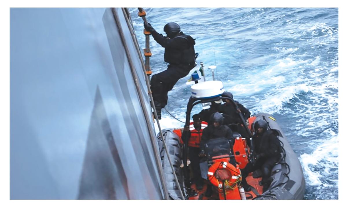 A Nigerian Navy special boat service element practices boarding a ship in the Gulf of Guinea.