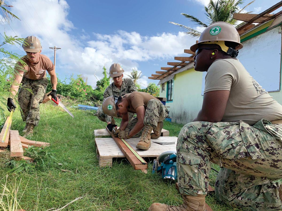 Seabees assigned to Naval Mobile Construction Battalion 3, Det. Tinian, measure materials for the construction of an emergency temporary roof for a home that was damaged during Super Typhoon Yutu.