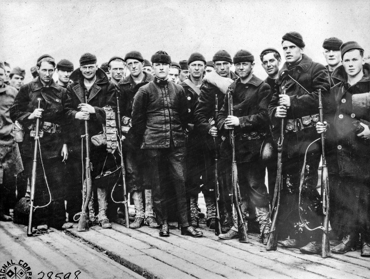 A portrait of the 50 man landing force from the USS Olympia (C-6) posing with their weapons