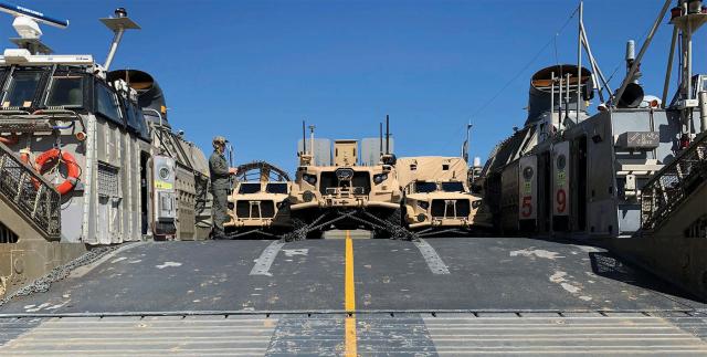 Marine Corps vehicles loaded on board a Navy landing craft air cushion