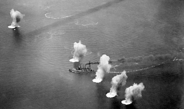 The radio-controlled Coast Battleship No. 4 maneuvers through 14-inch shell splashes during fleet gunnery practice off Panama on 22 March 1923. The ex-Iowa was sunk the next day during further practice.