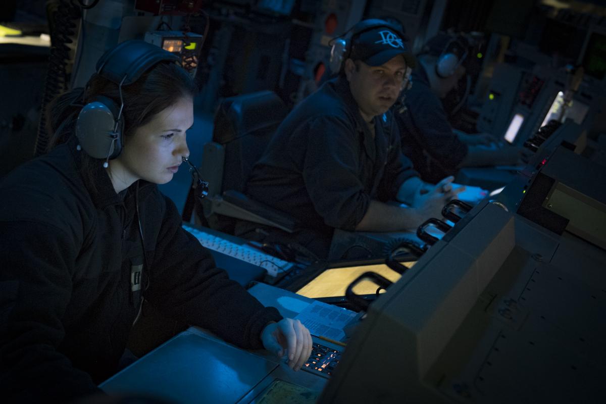 Lieutenants standing watch in the CIC of the USS Donald Cook (DDG-75)