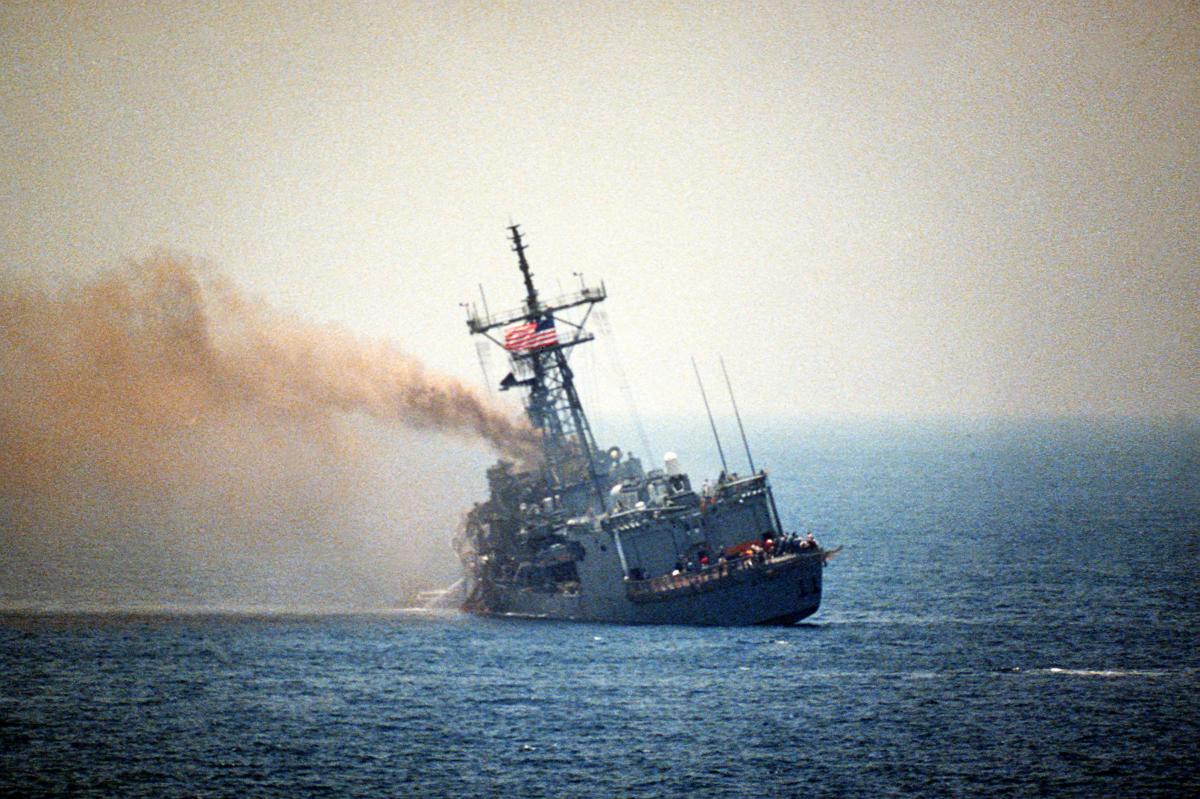 Port quarter view of the guided missile frigate USS STARK (FFG-31) listing to port after being struck by an Iraqi-launched Exocet missile, 5/18/1987