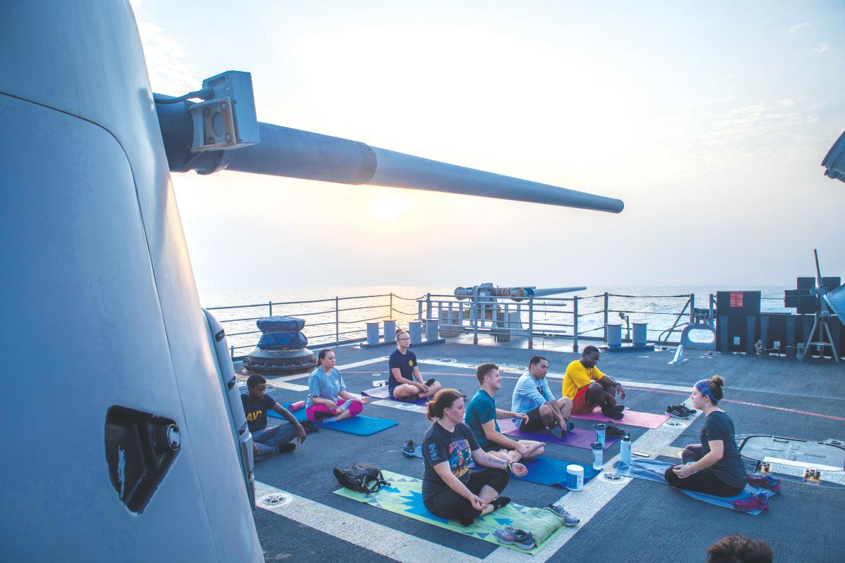 Sailors perform yoga on the fantail of the Ticonderoga-class guided-missile cruiser USS Princeton (CG-59)