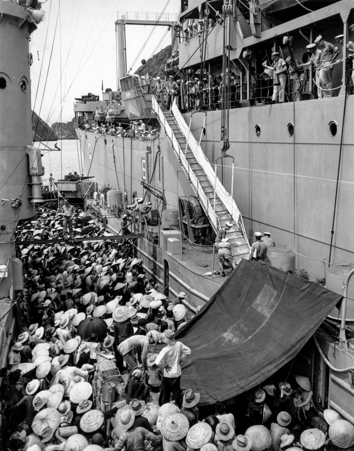 Voting with their Feet: Vietnamese refugees are transferred from a French ship to the USS Montague (AKA-98) during Operation Passage to Freedom.