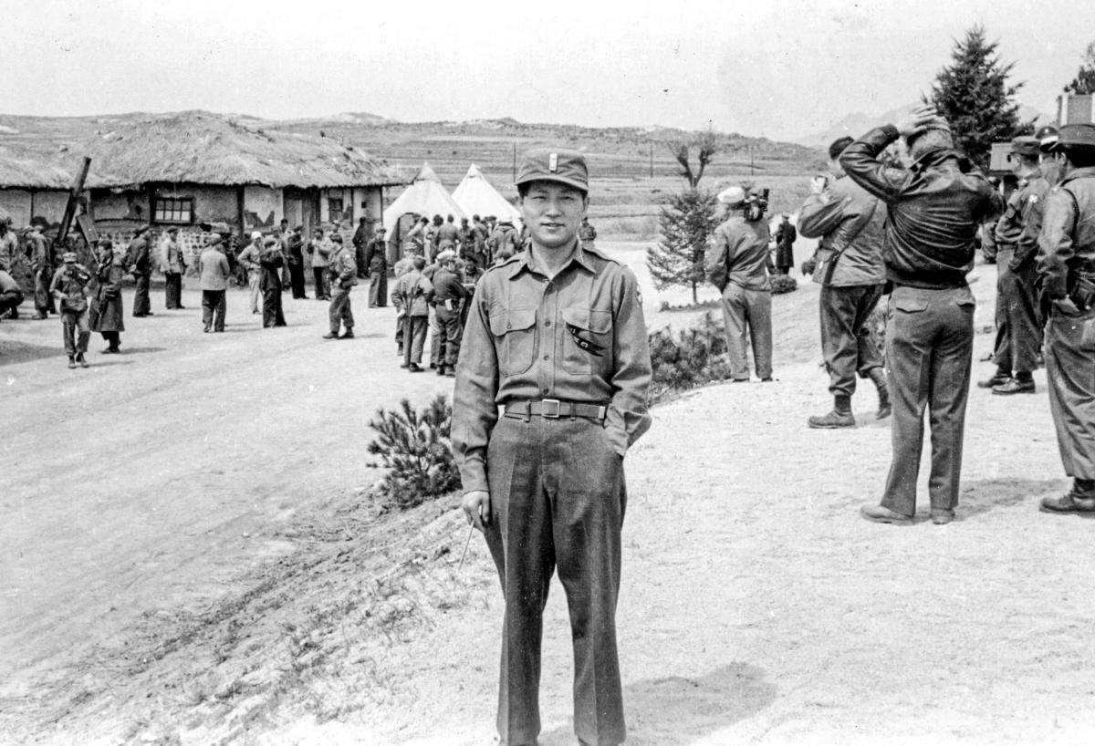 John K. C. Oh standing outside in Korea in 1953