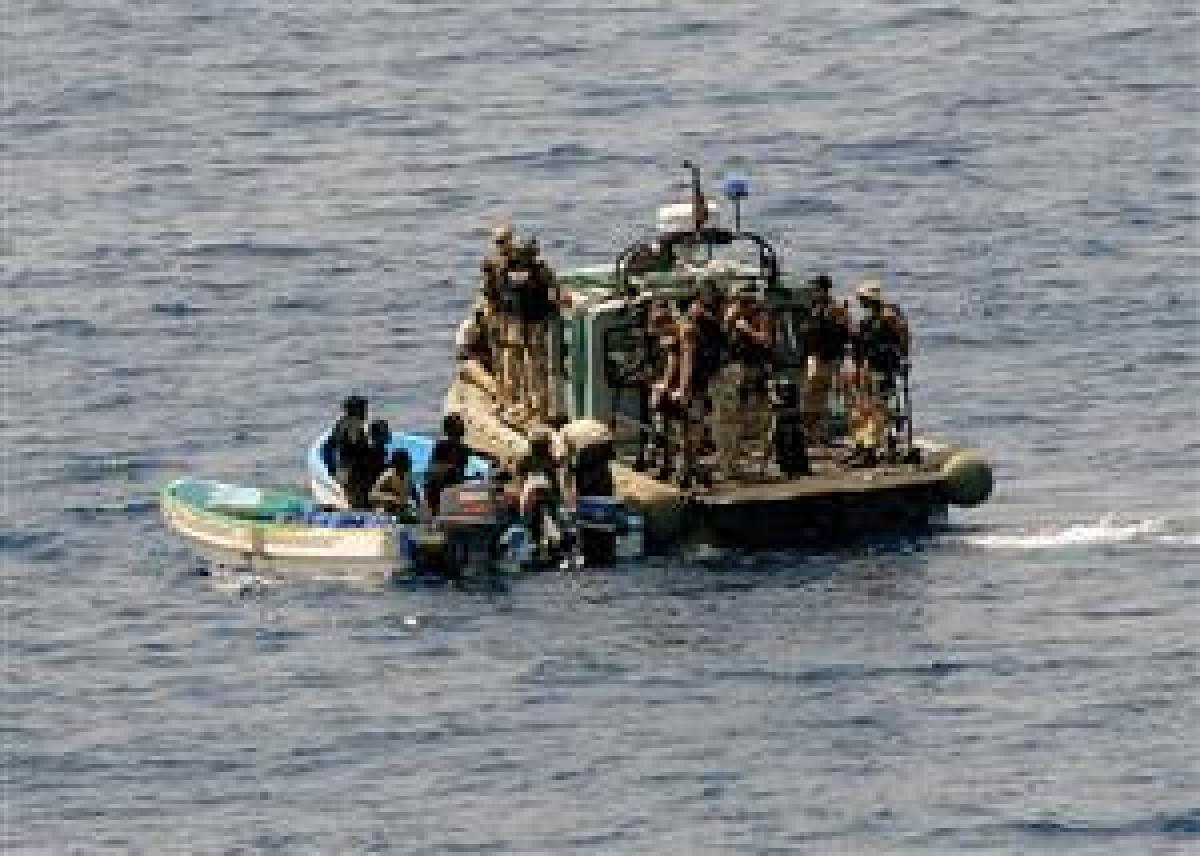 A visit, board, search, and seizure team from the USS Ashland (LSD-48) board and inspects two fishing skiffs for suspected pirate activity on 6 May. At some point soon, the author says, the United States must assess various courses of action to alleviate 