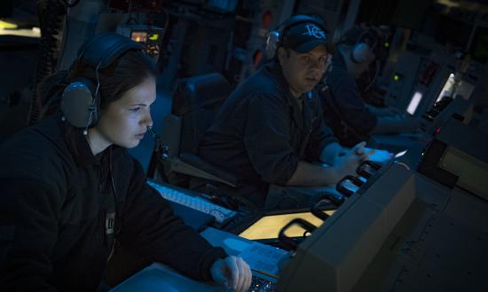 Lieutenants standing watch in the CIC of the USS Donald Cook (DDG-75)