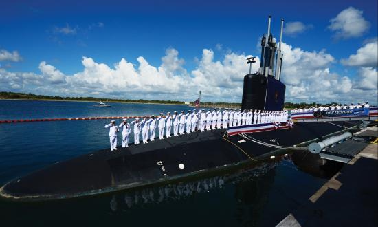 The crew of the USS Indiana (SSN-789) salute after bringing the boat to life after her commissioning.