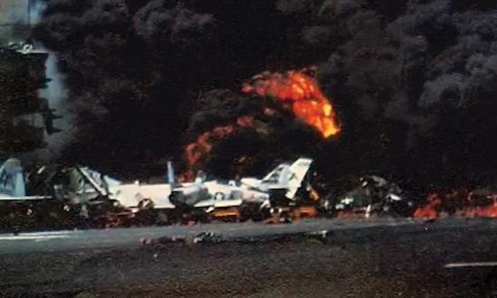 USS Forrestal is engulfed in explosions