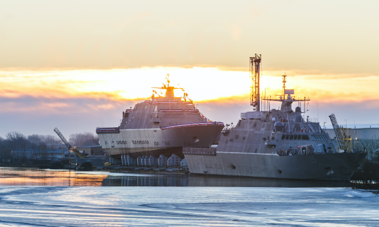 The Navy prepares to christen the future littoral combat ship USS St. Louis (LCS-19), left, in Marinette, Wisconsin, as the USS Billings (LCS-15) is under construction and preparing for commissioning.