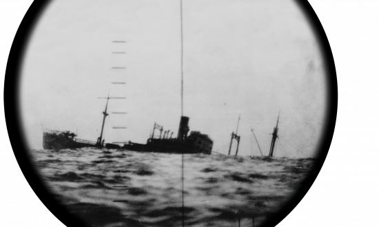 A sinking Japanese ship seen through the periscope of a U.S. submarine.