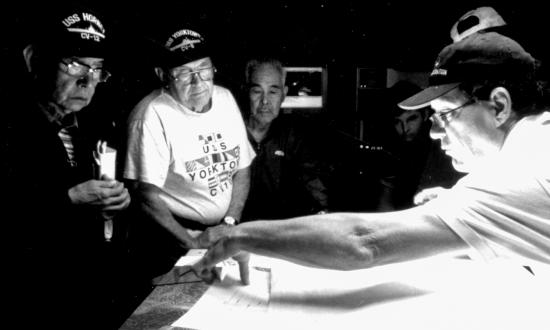 Robert Ballard (above) shows sonar  charts to Hiruo Yoshino, Bill Surgi, and Yuji Akamatsu. Yoshino and Akamatsu  served on the Japanese carrier Kaga,  Surgi on the Yorktown.