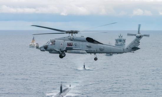 US. Navy Seahawk helicopter flies over USS Toledo and HNoMS Ures submarines as they participates in Dynamic Mongoose
