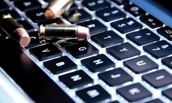 Bullet resting on laptop keyboard