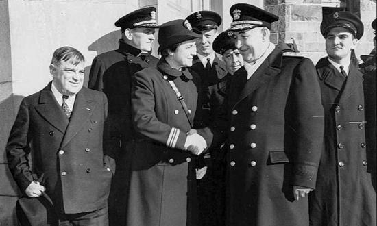 Lieutenant Commander Mildred McAfee shakes hands with Rear Admiral Randall Jacobs at a Female Officer Training School commissioning ceremony at New York City’s Hunter College in early 1943.