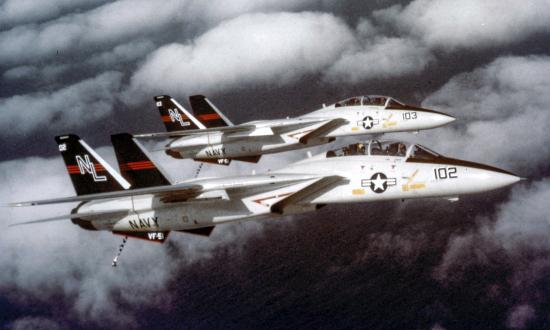 Aerial side view of two U.S. Navy F-14A Tomcat fighter aircraft of VF-51 flying in formation.