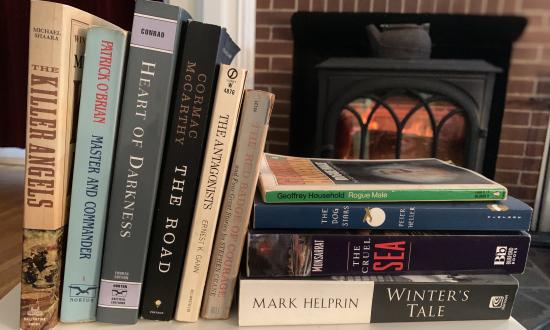 Books on a table by a fireplace
