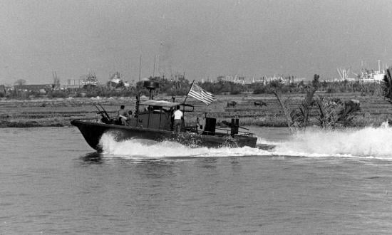 A PBR, downstream from Saigon, heads for home at the end of her patrol.
