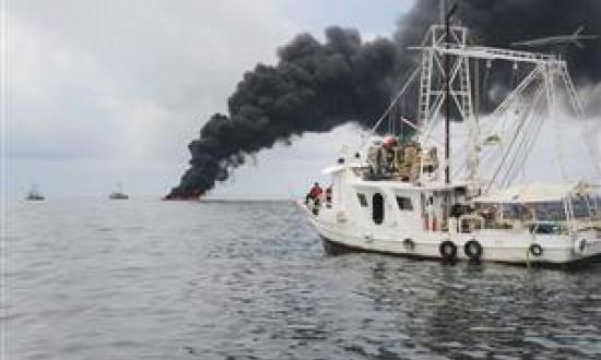 A Mess in the Gulf Crew members of the Gulf Handler, a contracted fishing vessel, observe a controlled oil burn in the Gulf of Mexico on 5 May. Locals conducted the in-situ burn in partnership with BP, the U.S. Coast Guard, and other federal agencies to a