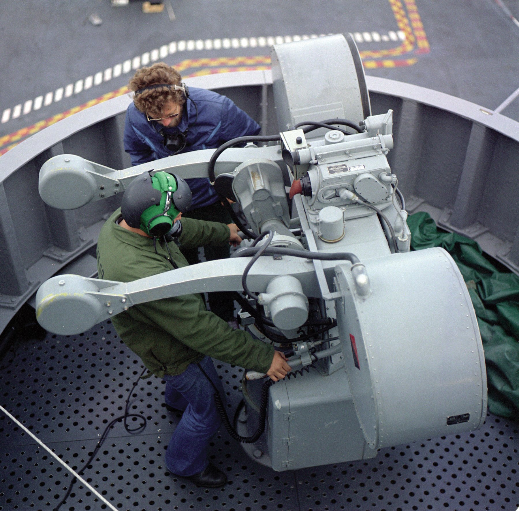 Sailors working a MK 115 fire control system director