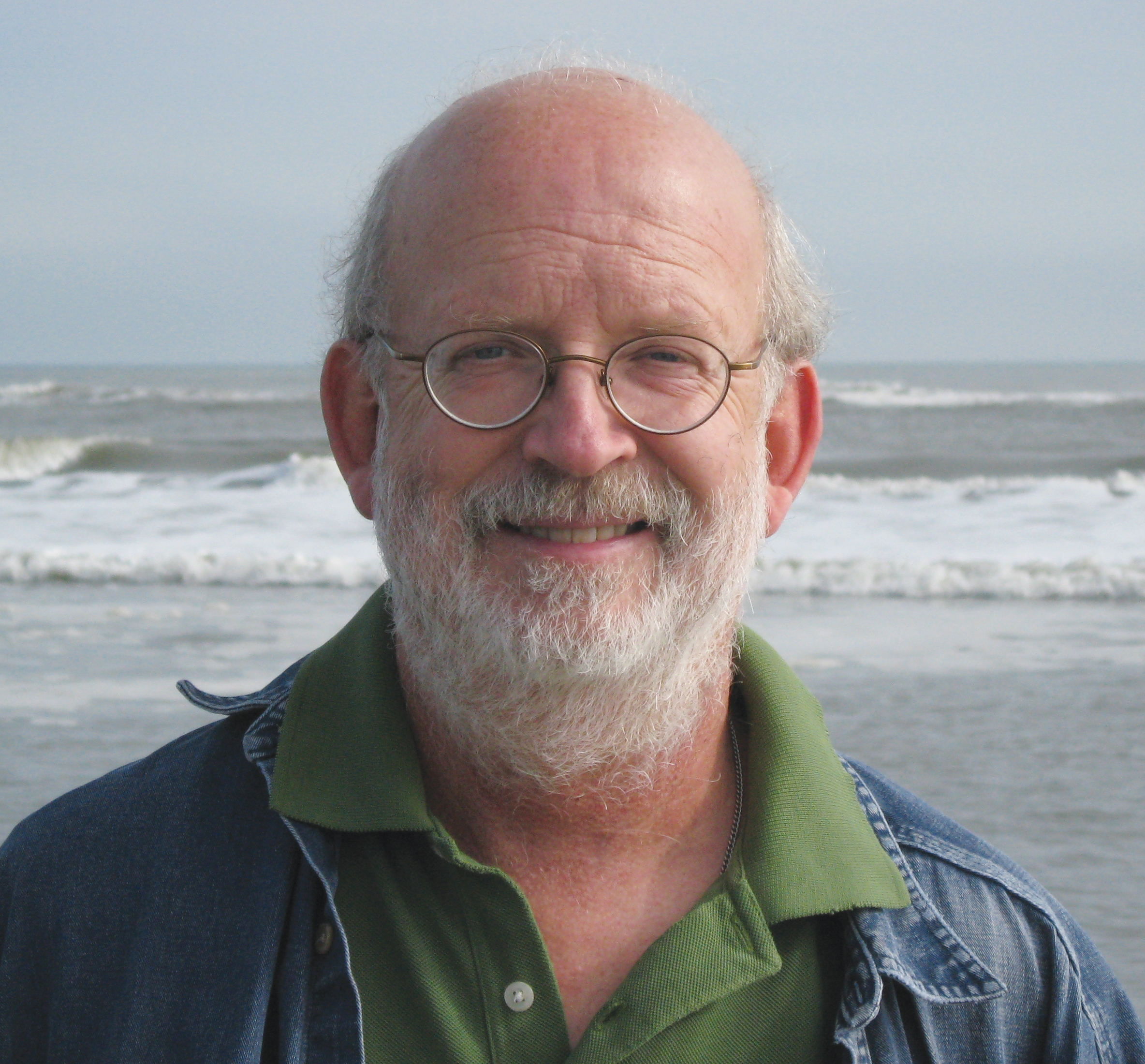 Tim McGrath standing by the ocean