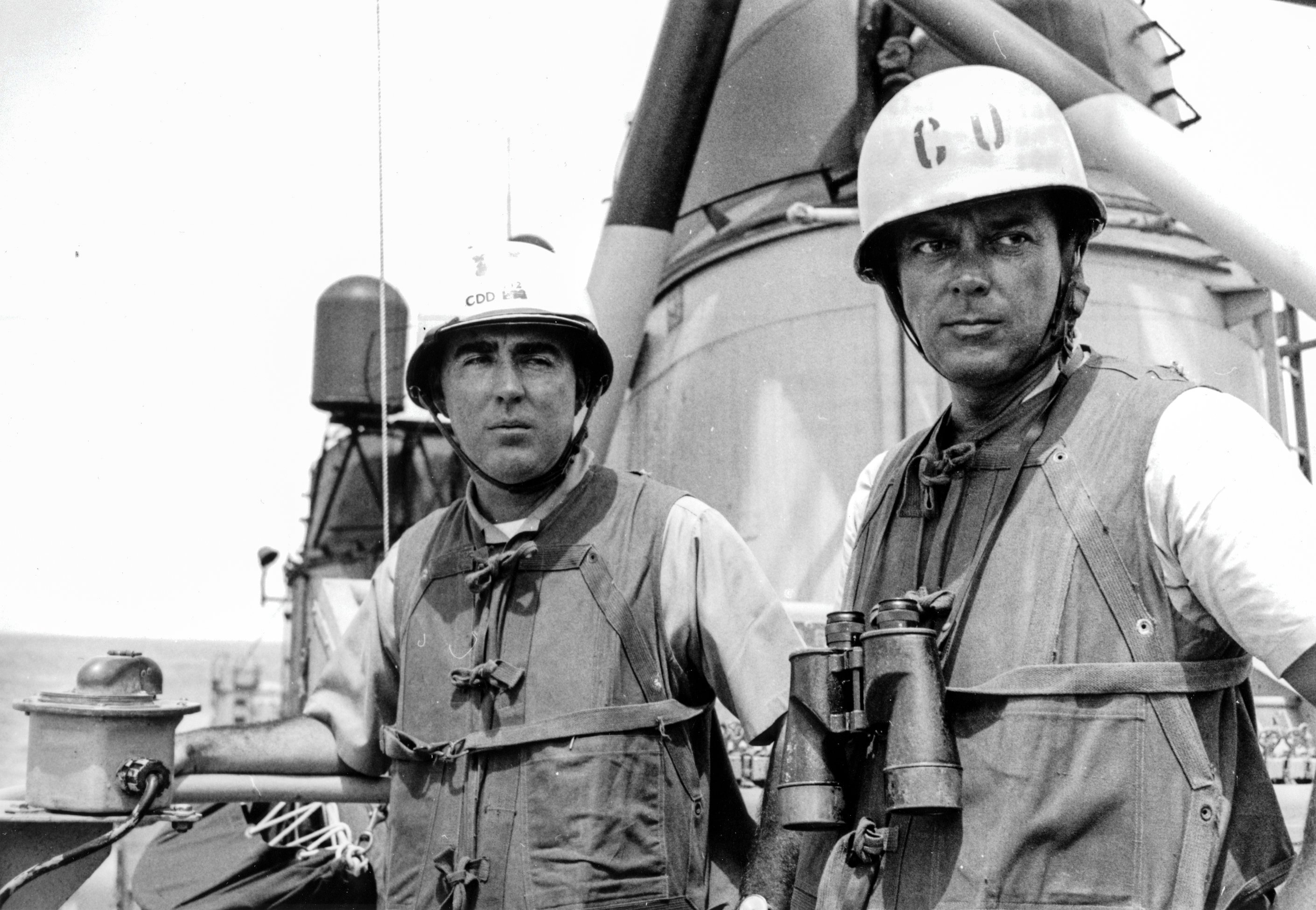 Navy Captain John J. Herrick standing in battle dress with Maddox skipper Commander Herbert L. Ogier on board the destroyer