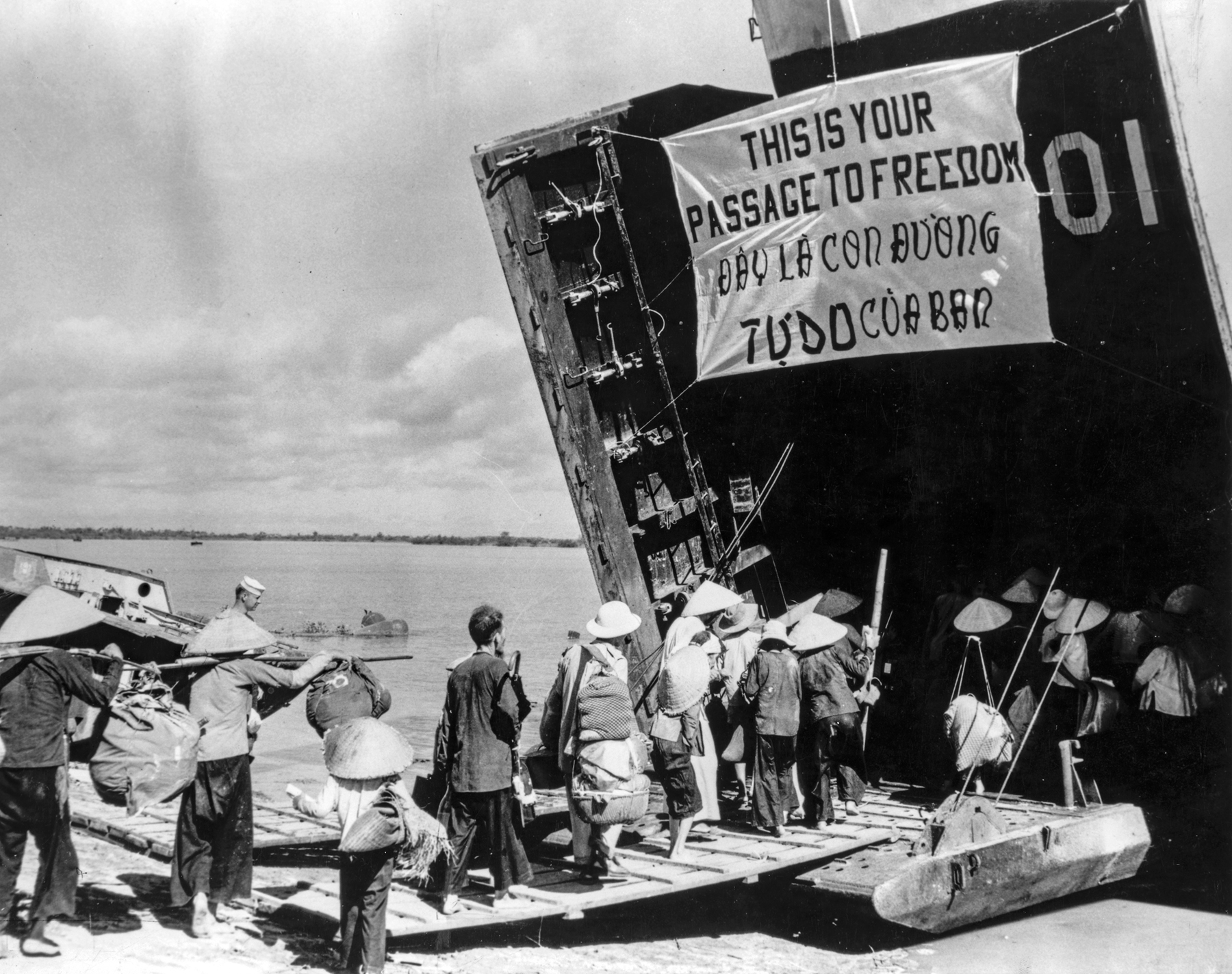 Refugees file onto USS LST-901 during Operation Passage to Freedom.