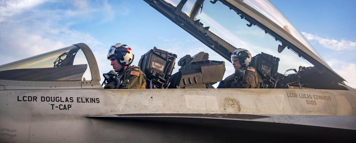 Pilots perform perform final checks on an F/A-18F Super Hornet aircraft before flight operations