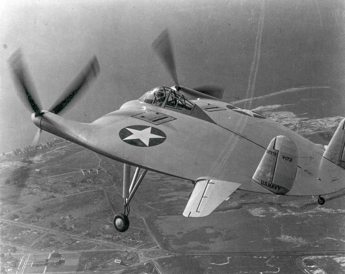 Air-to-air left side rear view of the Chance Vought V-173 aircraft in flight.
