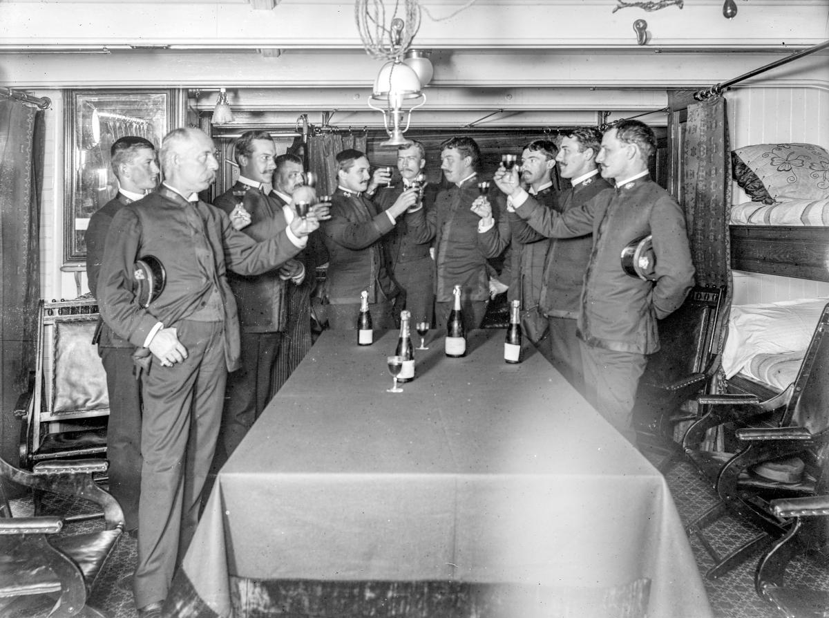 Officers on board the cruiser USS Newark (C-1) raise a toast in 1891. T
