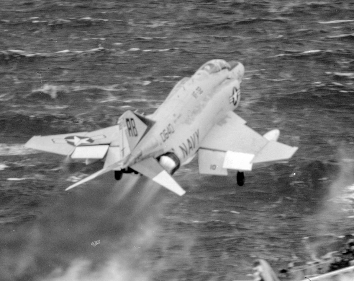 Right rear view of an F-4 Phantom II catapulting off an aircraft carrier