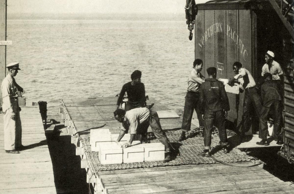 Sailors unload ammunition earmarked for the Pacific war from a boxcar on the Port Chicago pier