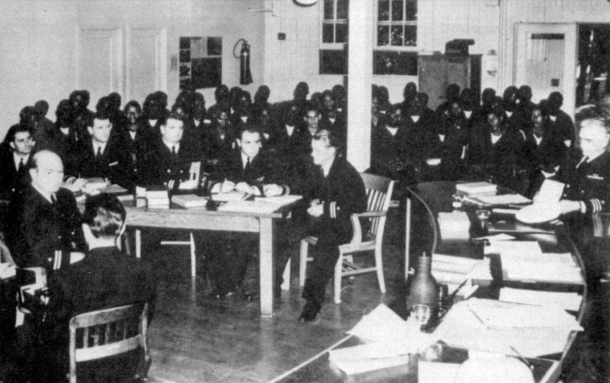 50 accused Port Chicago sailors seated behind their defense team