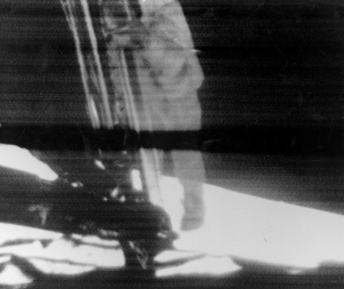 Television still of Neil Armstrong descending onto the moon