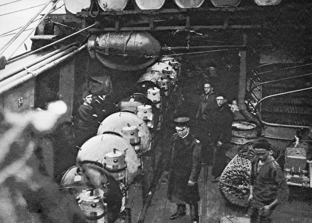 Mk 6 mines, with floats attached and resting on box-like anchors, are ready to be dropped from a U.S. minelayer into the North Sea