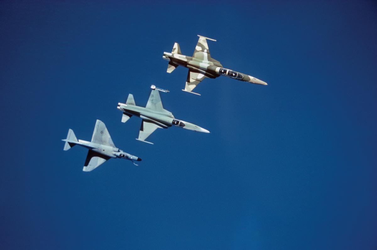 Overhead view of three Navy adversary aircraft, two F-5 Tiger IIs and one A-4 Skyhawk