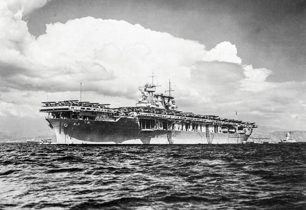 Surface port bow view of the USS Yorktown (CV-5) riding at anchor