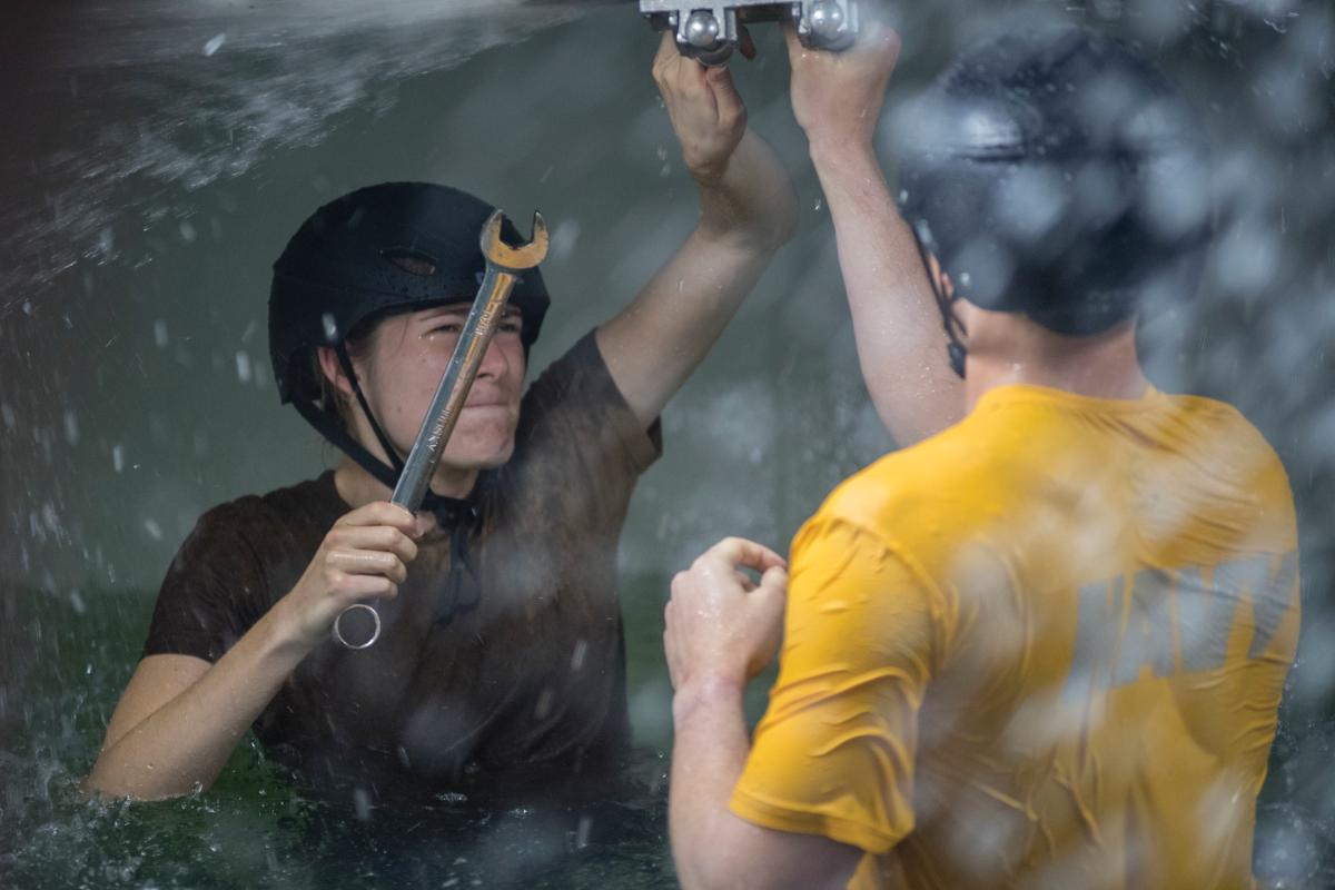 Naval ROTC Midshipmen patch a leaking pipe on the USS Buttercup