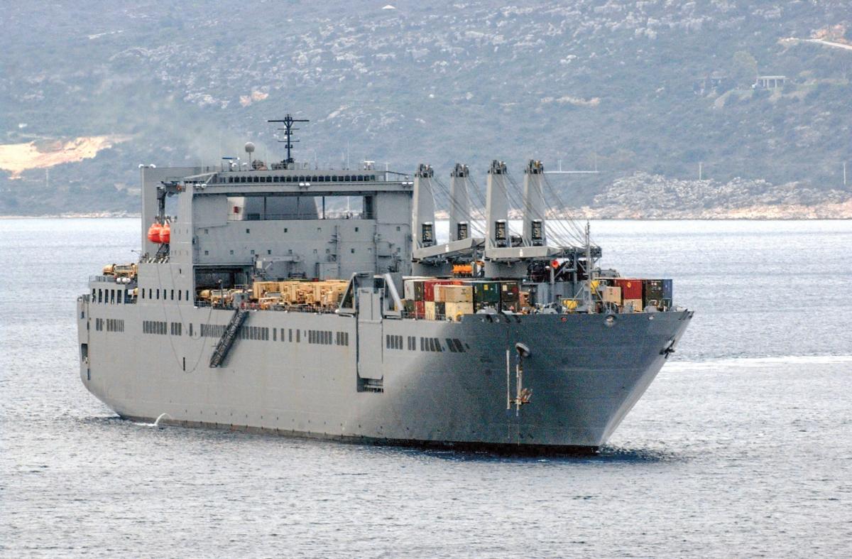 USNS Benavidez (T-AKR 306) heads out of Souda harbor following a brief port visit.