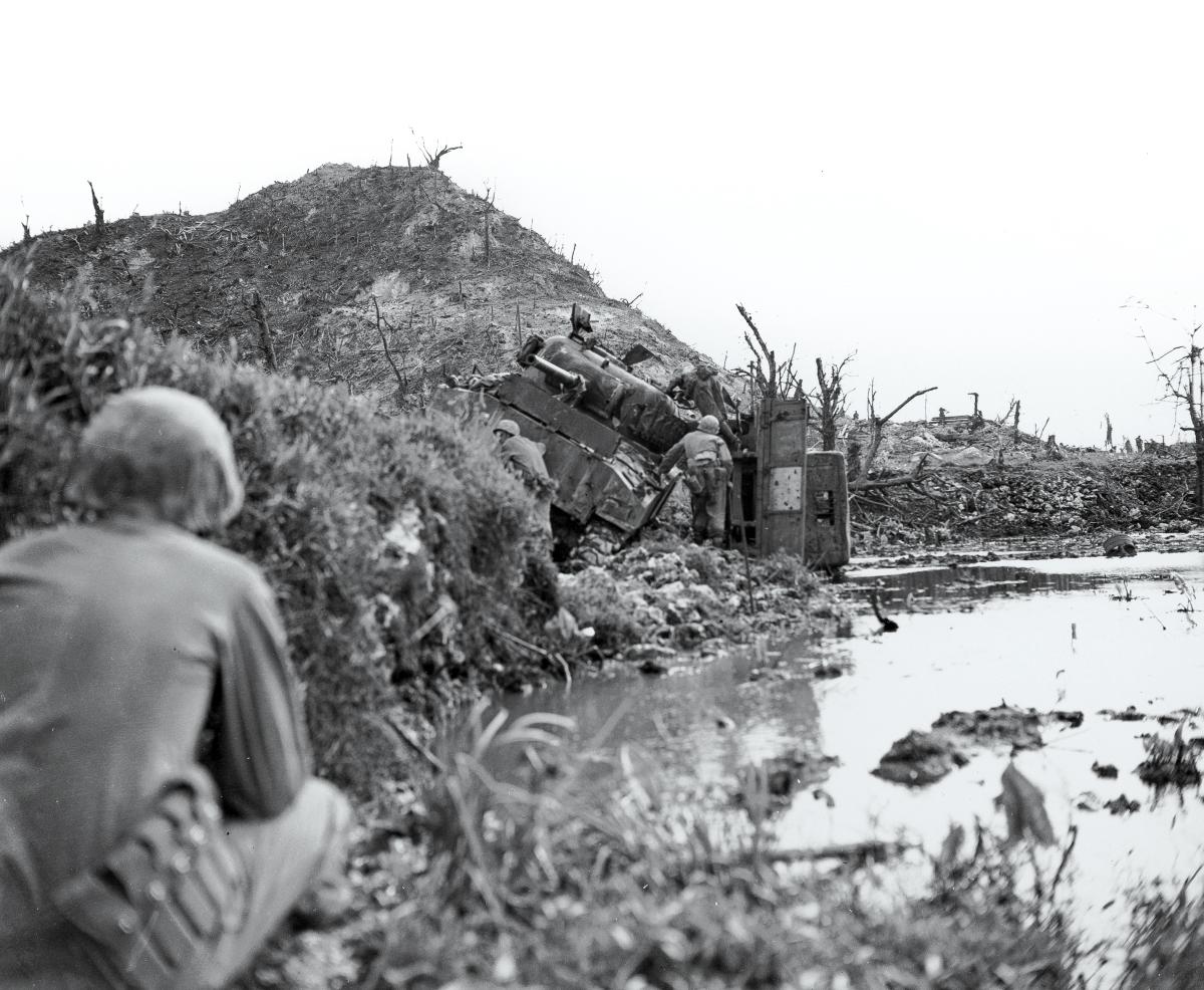 Disabled Sherman tank and Hill 100 on the island of Peleliu