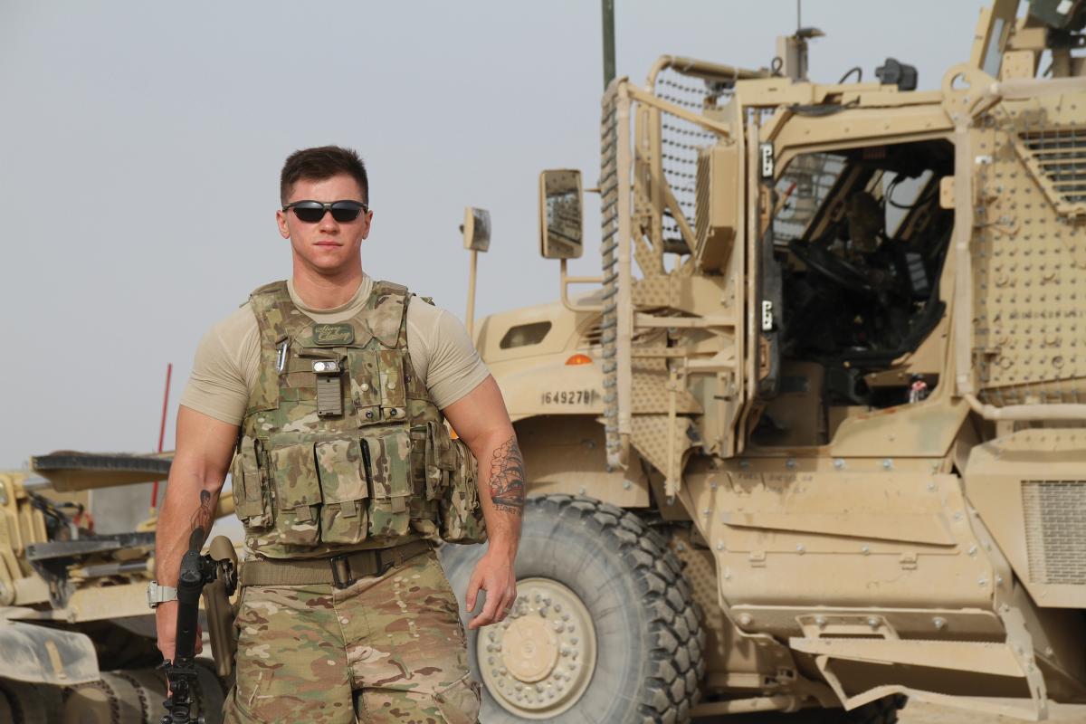 Staff Sergeant Logan Ireland, U.S. Air Force, posing next to a truck