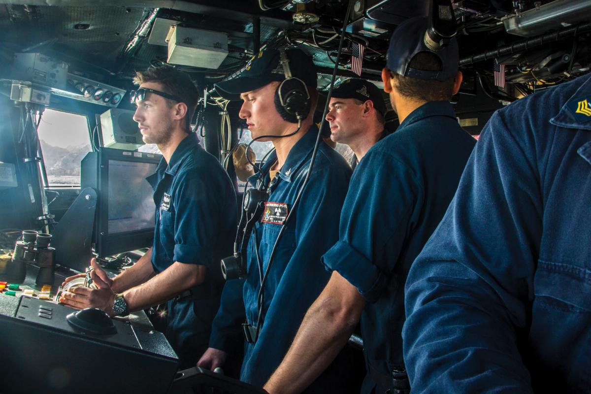 Machinist Mate 3rd Class Aaron Picklesimer steers the Cyclone-class coastal patrol ship USS Whirlwind (PC-11)