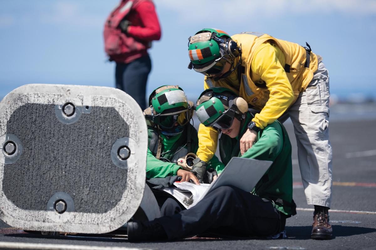 Sailors review instructions before flight operations on the flight deck of the aircraft carrier USS John C. Stennis (CVN 74) in the Indian Ocean, March 7, 2019. 