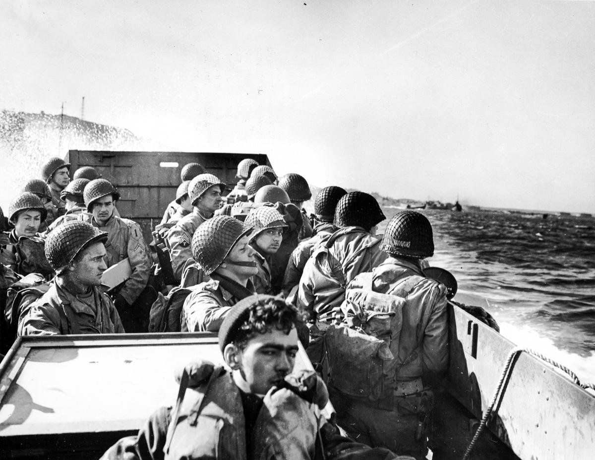 Troops prepare to disembark from their Coast Guard-manned landing barge onto the beaches of Normandy