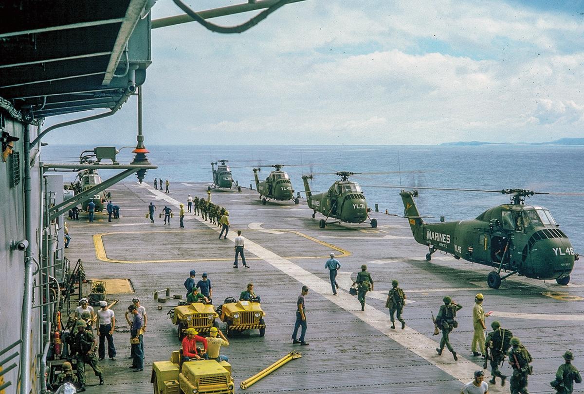 Marines move toward waiting UH-34D helicopters of HMM-362 on board the USS Valley Forge (LPH-8)