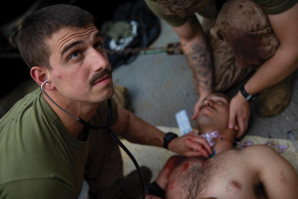 A U.S. Marine using a cric cit during a casualty scenario in 2018